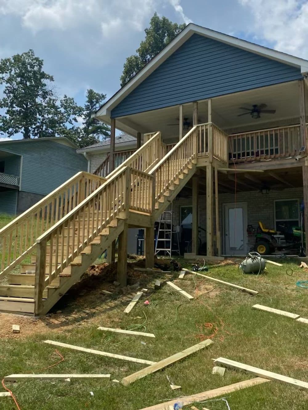 New wooden deck and staircase under construction at a residential home.